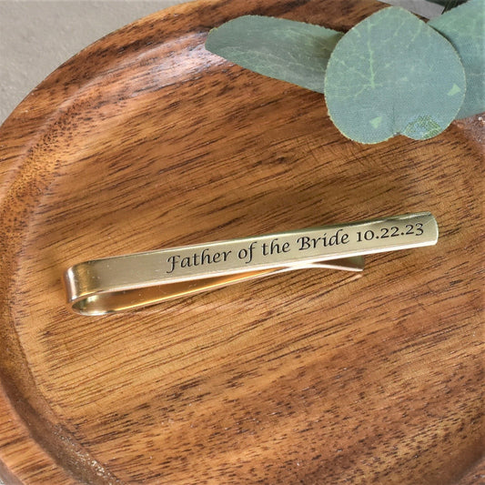 Engraved long 2.5 inch gold brass tie bar with custom calligraphy text and date.  Features satin finish and blackened text.