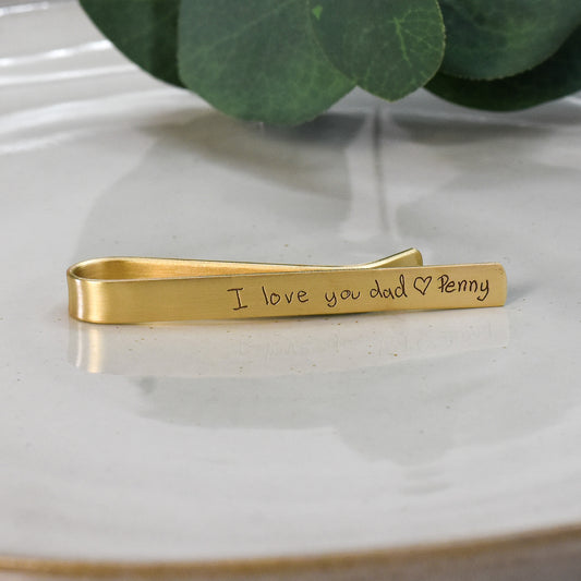 Custom engraved handwritten text on gold brass tie bar.  For father on wedding day.