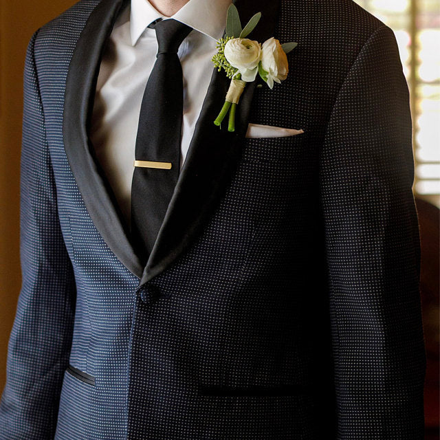 Man pictured in suit and tie with personalized gold tie bar slide custom handmade by 321 Simple Creations. 