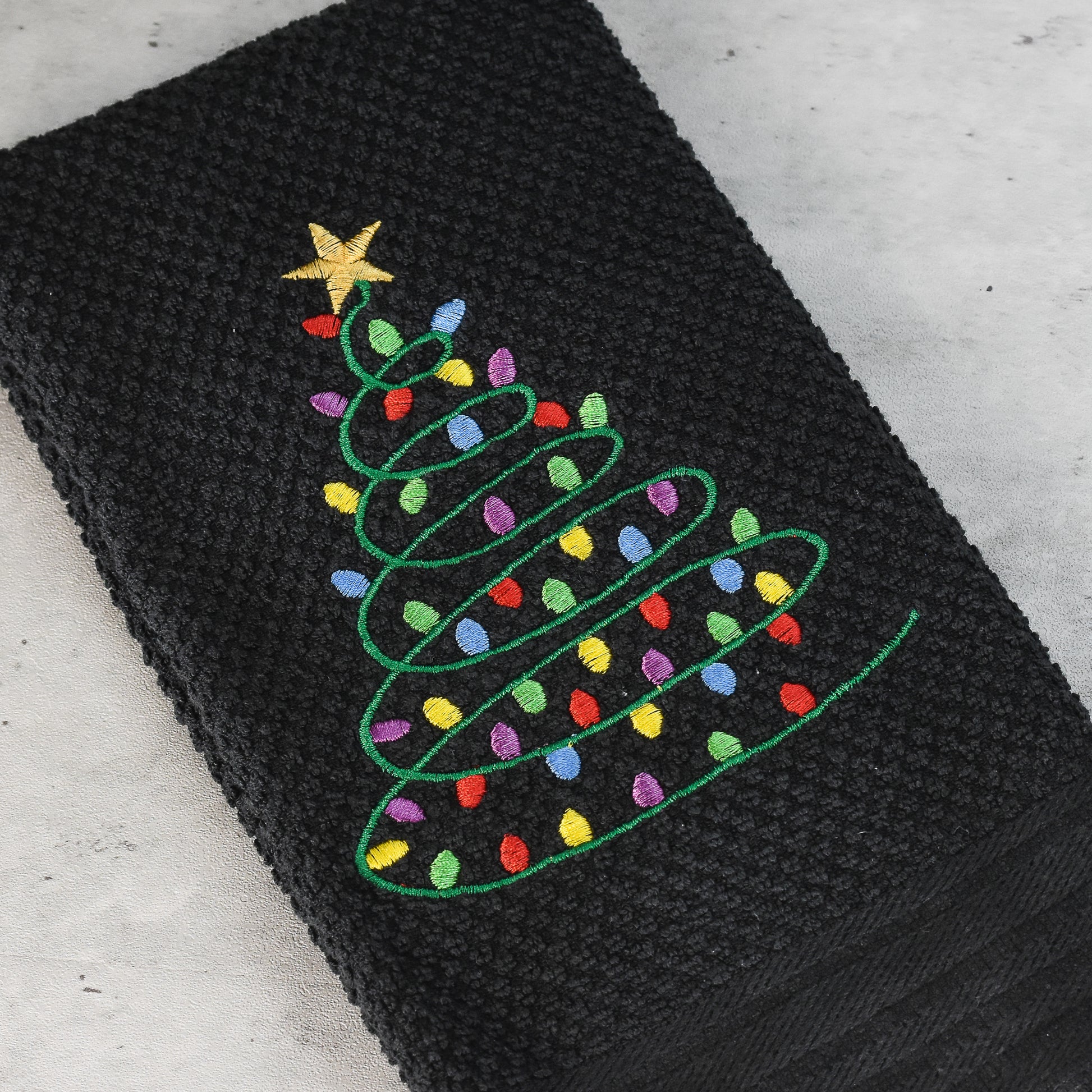Embroidered Christmas Tree Design with lights on Black 100% cotton waffle weave toweling