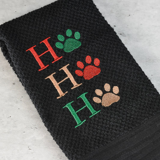 Embroidered HO HO HO Dog paw design on black waffle weave toweling