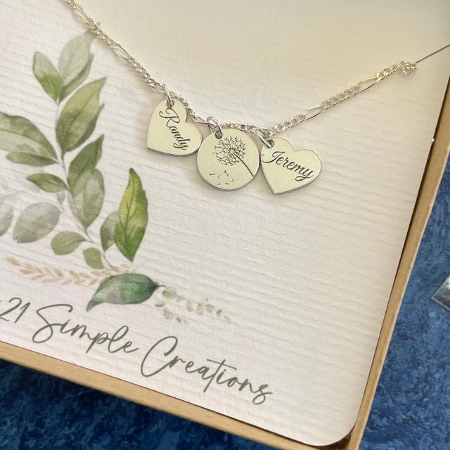 Photo from customer review of custom engraved sterling silver anklet with 2 heart charms with names and 1 center circle with dandelion design made by 321 Simple Creations.