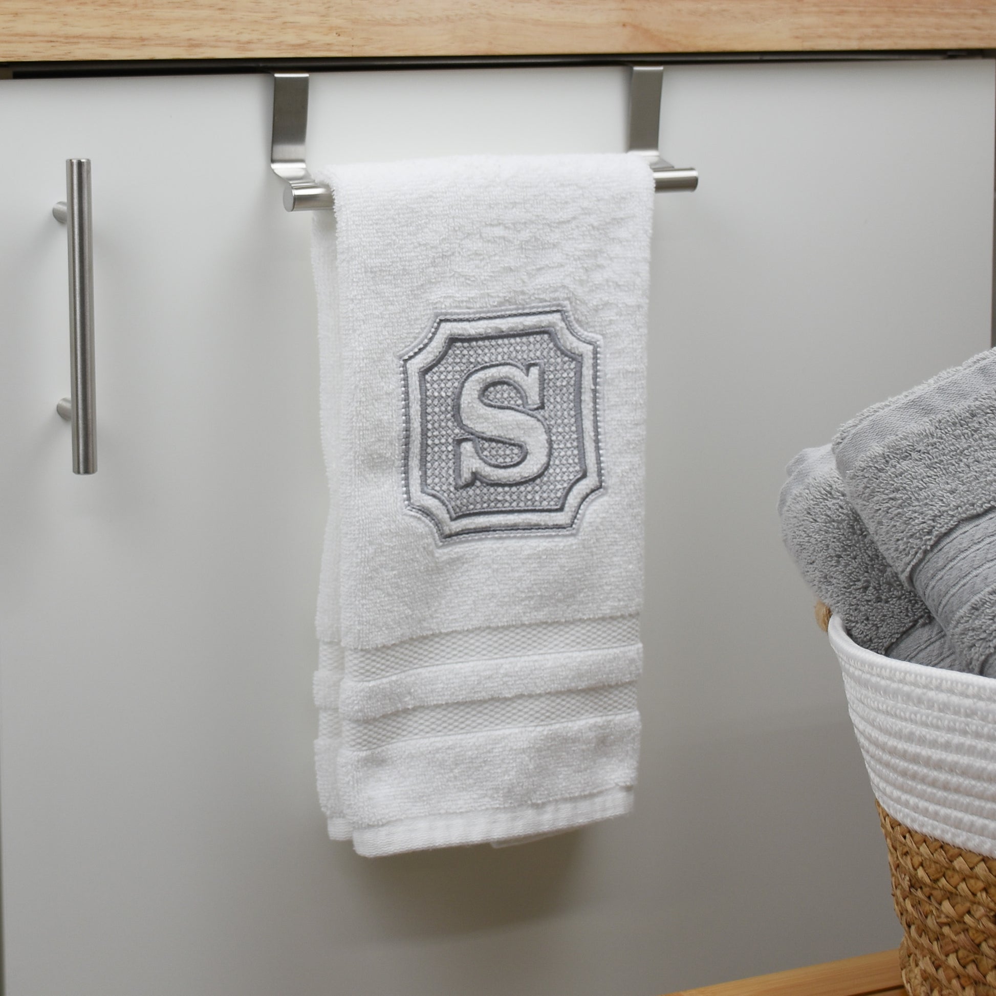 custom embroidered hand towel on towel bar hanging in bathroom