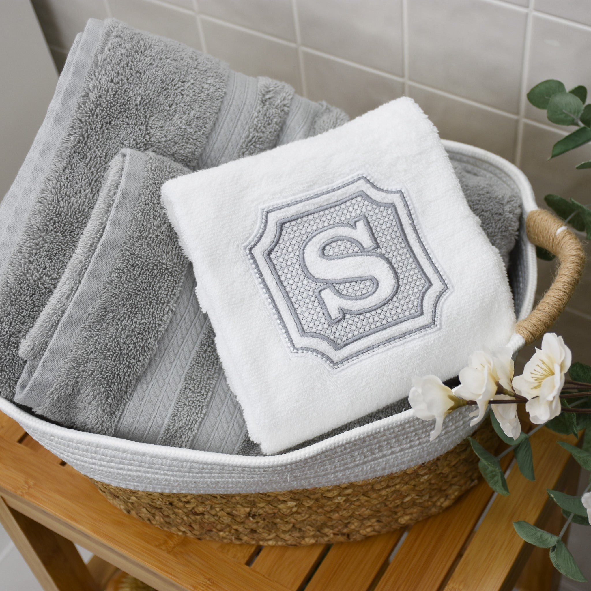 Personalized embroidered hand towel with S initial with coordination silver bath towels