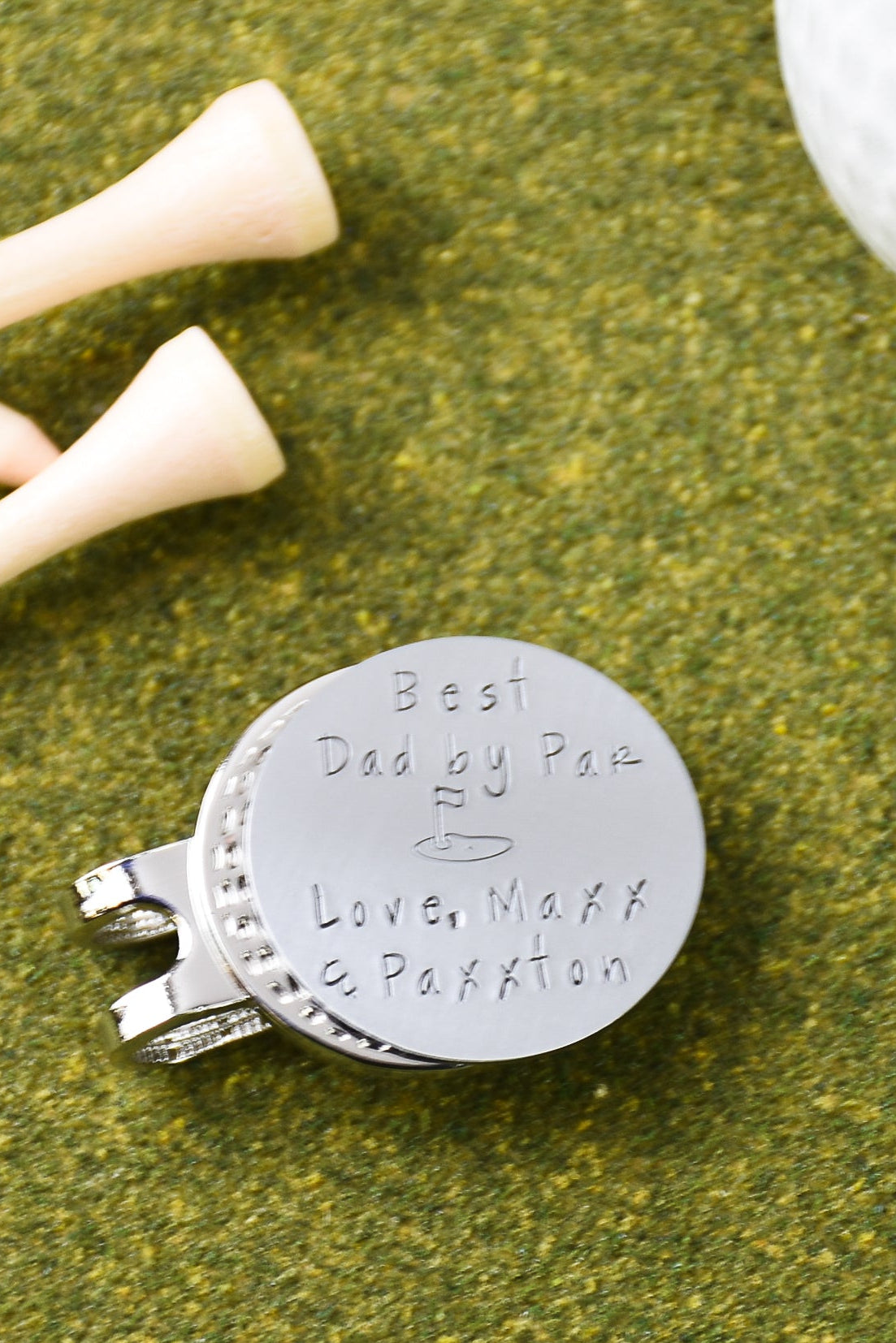Custom engraved stainless steel golf marker with text "Best Dad by Par Love, Maxx & Paxxton" with magnetic hat clip handmade by 321 Simple Creations.