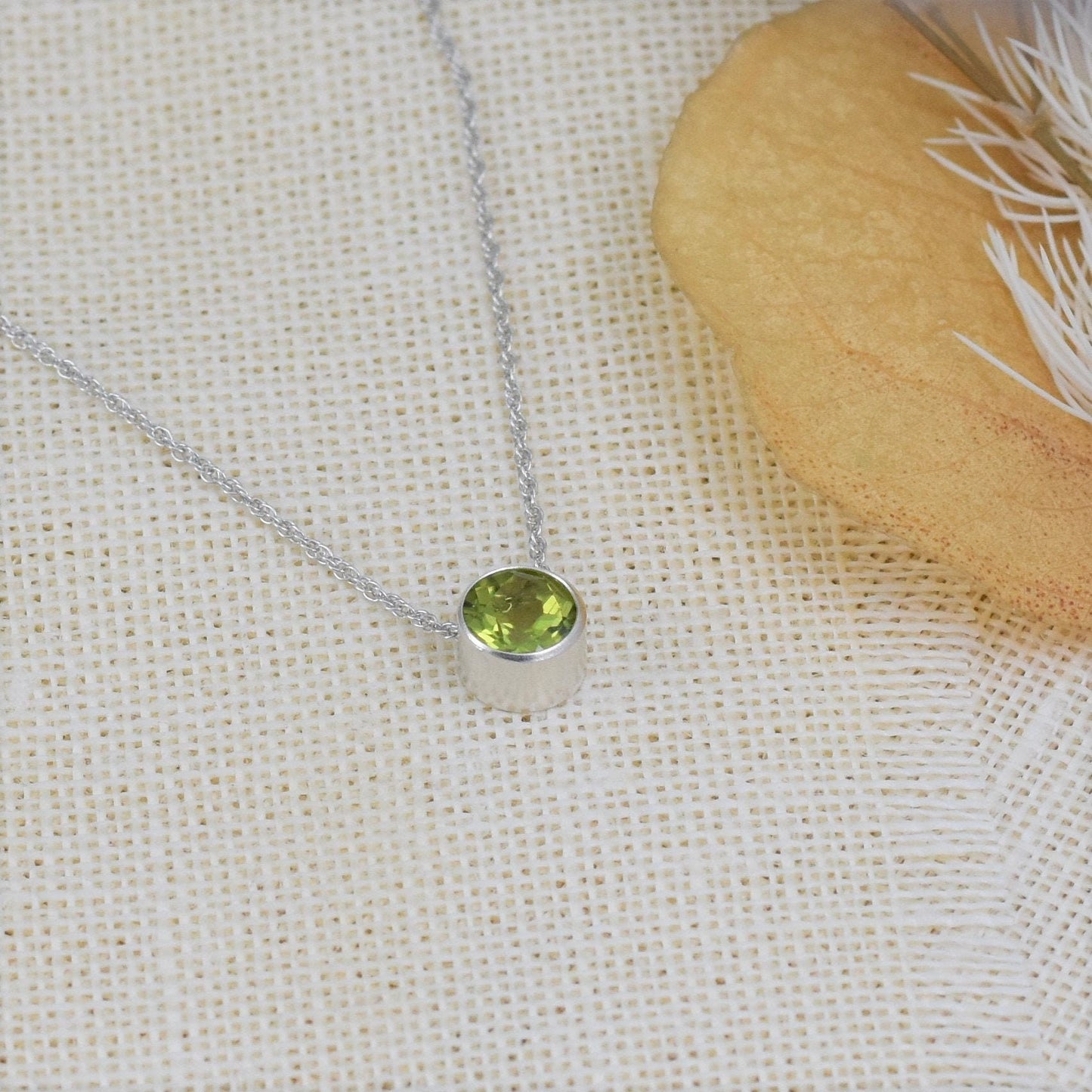 Sterling silver gemstone slider necklace with bezel set peridot gemstone for August birthday.